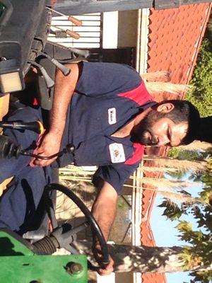 My partner, Marlon, he looks good driving a tractor that we were doing maintenance on.