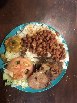 Pork chops white rice beans tostones salad