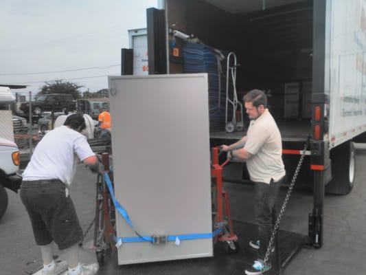 MIKE AND KENDALL MOVING A LARGE VAULT OFF THE TRUCK