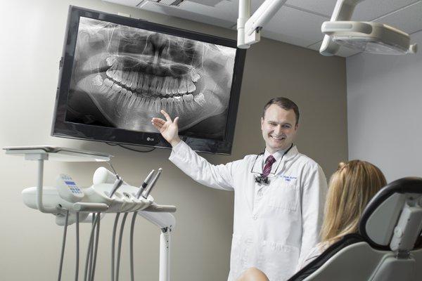 Dr. Rother going over x-rays in an operatory.