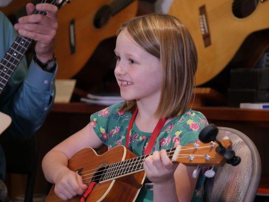 A young ukulele player taking a lesson. Photo by Lisa Strong.