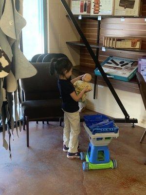 Cute shopping cart and some toys in there to keep the littles occupied