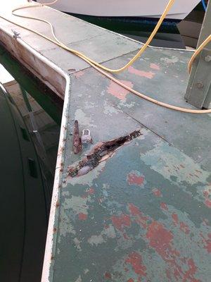 Significantly large rot spot and hole in the dock. An adult's foot could easily be caught in this.