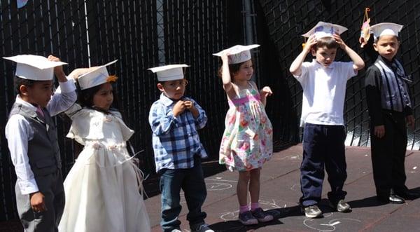 Kids standing at their Pre-K graduation celebration.