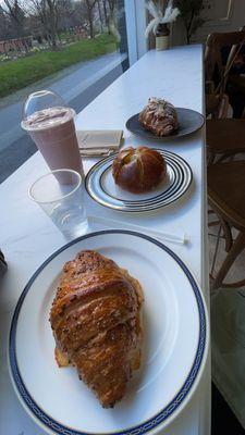 entire order including an almond croissant, ham and cheese croissant, garlic and cream cheese bun, and a strawberry smoothie