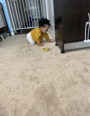 My son with tape and playing with the door stopper at daycare being photographed.