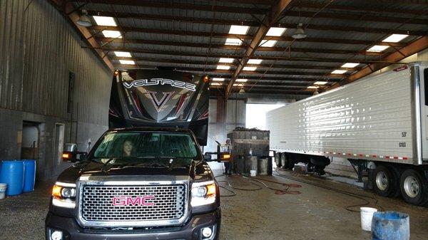 The truck and battle wagon getting cleaned