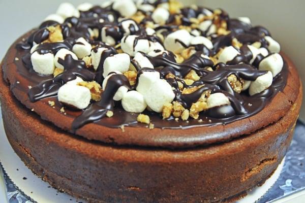 chocolate cheesecake, chocolate crust, layers of chocolate ganache, topped with mounds of walnuts, marshmallows and rich ganache