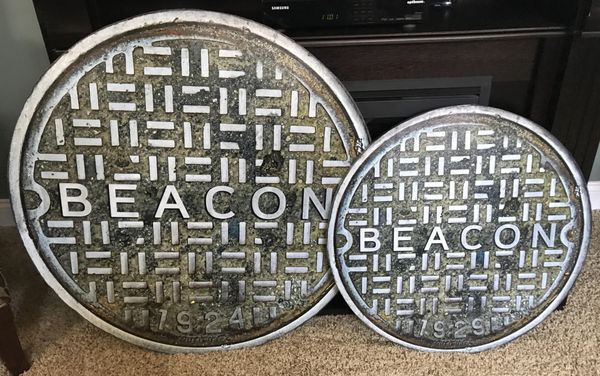 Extra Large 32" Manhole cover next to a 24" standard size manhole cover.