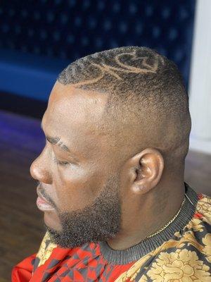 Mid high bald fade with design and beard enhancement