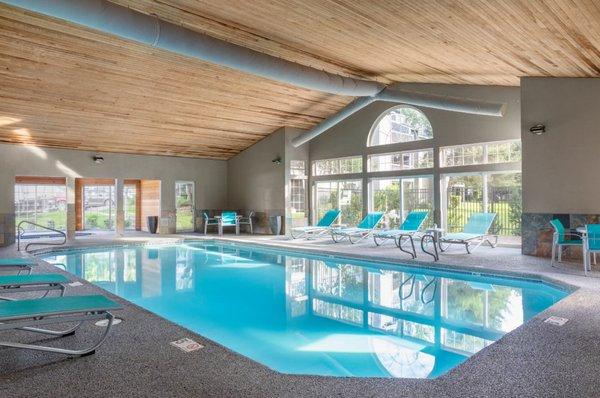 Indoor Community Pool With Lounge Chairs And Windows