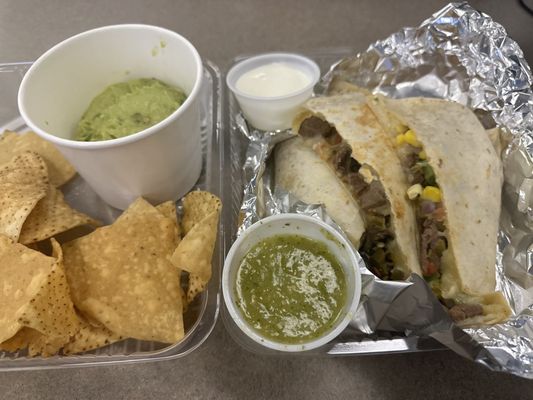 Steak quesadilla and a side of guac and chips