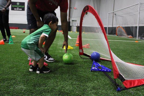 Here, kids learn young the objective of soccer; get the ball in the goal!