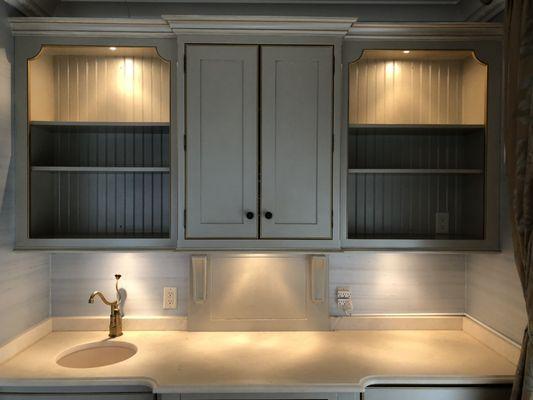 Glazed and gilded cabinetry.