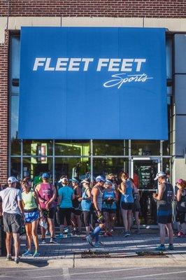 The Fleet Feet Sports Elmhurst store facade in morning light before a marathon training group run.