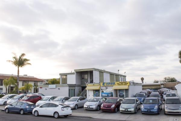 Front of Dealership, full lot of Prius.