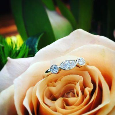 Engagement ring combining elements of old & new by using diamonds from the groom's grandmother's ring to create a custom piece for the bride