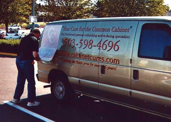 Duane adding decals to a van.