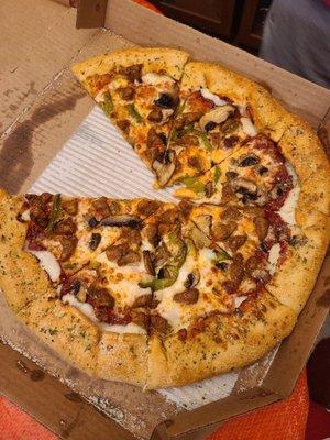 Large Stuffed Crust 3-Topping pizza with garlic crust. Italian sausage, mushrooms & Bell peppers. Lack of toppings on all of the slices