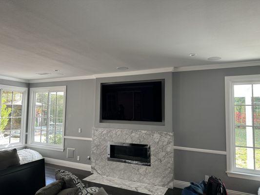 5.1 Surround sound system powered by a Yamaha receiver. Flush mounted 86" LG OLED.