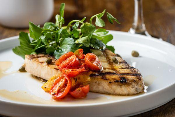 Swordfish with marinated eggplant, semi-dry tomatoes and mix of greens