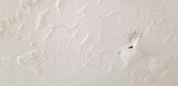 My bathroom ceiling which leaks water in my tub.