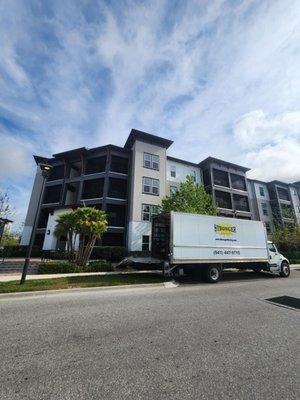 Stronger Moving truck unloading at a new apartment.