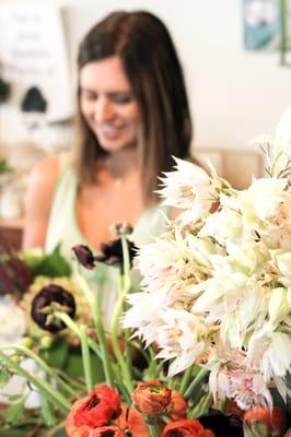 Owner Meagan Lissner making a wedding bouquet.