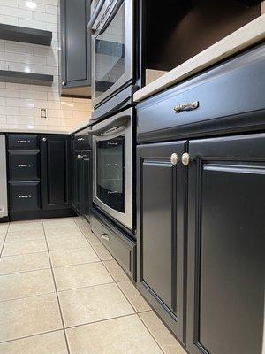 Kitchen cabinets painted from wood to this beautiful black. A kitchen remodel at a fraction of the cost!