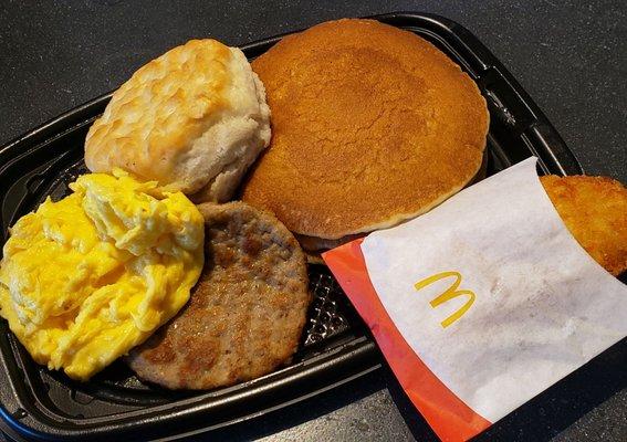 Big Breakfast with hotcakes ($5.29) includes a sausage patty, scrambled eggs, hash brown, and unnecessary biscuit