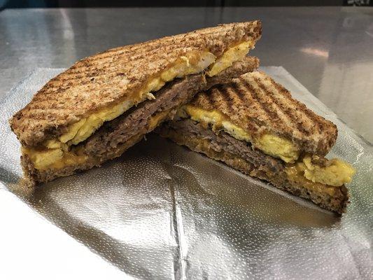 Breakfast Sandwich: sausage, egg, and cheddar cheese on Multigrain bread.