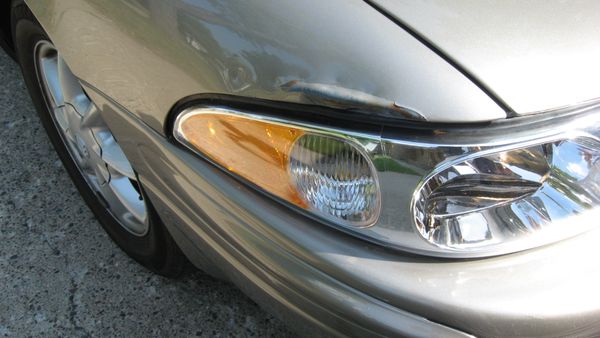 Damage just above right headlight.  Headlight was totaled, bumper is fine.  It's an edge dent.