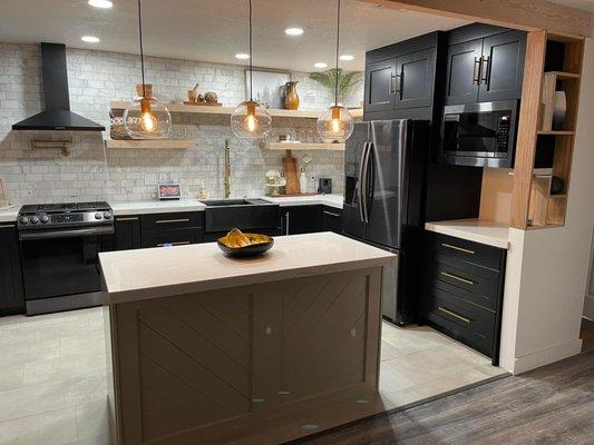 Hydro Black shaker style custom kitchen with a white oak island and matching floating shelves.