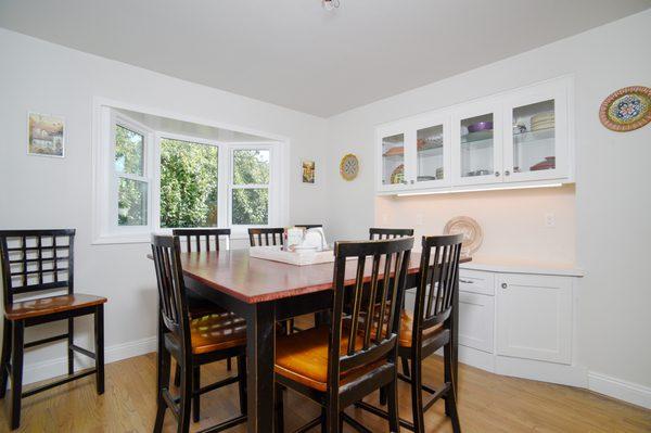 Dining room with new beveled glass cabinets and added bay window.