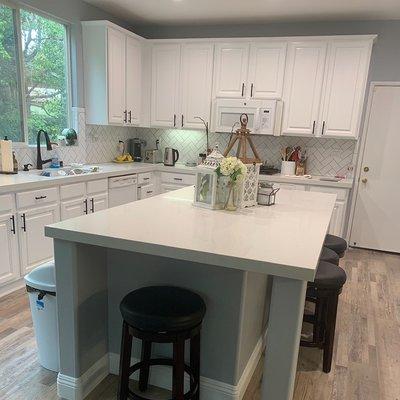 Reface your kitchen cabinets - get that modern look! White gives greater depth to any room.