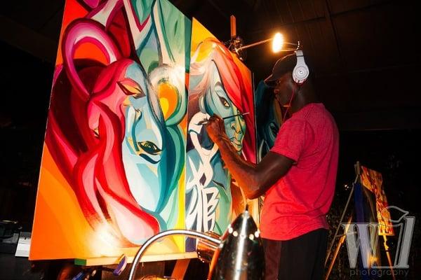 Artist on stage painting at 11AfterDark