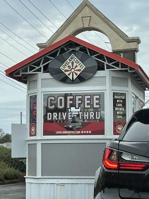 Cute little drive thru located in a parking lot.