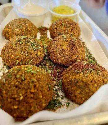 Falafel, crushed chickpeas, cilantro, onion, parsley, garlic with tahini sauce.