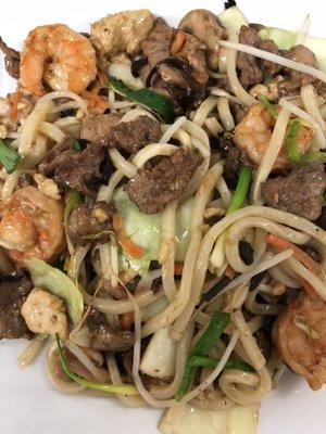 Yaki-udon Japanese soba noodles stir-fried with white meat chicken, shrimp, and beef along with vegetables.