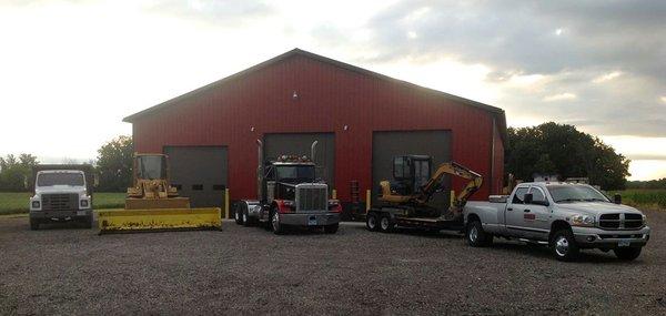 Sines Excavating LLC equipment in front of shop.