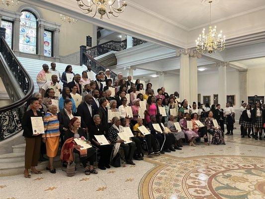 Women of color excepting their awards for being the first of something.