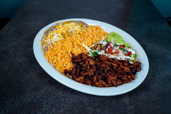 #8 Pork Plate: Tender pork marinated in red chile sauce, green sauce, or Shredded.Served with guacamole, pico de gallo, cabbage, beans and