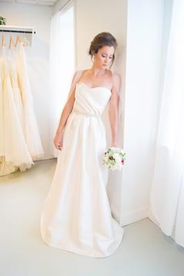 The Cumberland shown with a beaded bridal belt and statement earrings. This silk mikado gown stands well in its simplistic form.