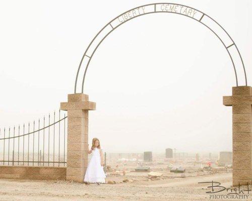 Concept photo of a young ghost at an old desert cemetery on a rare foggy morning.