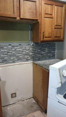 Installation of backsplash and kitchen painting after Fire damage.