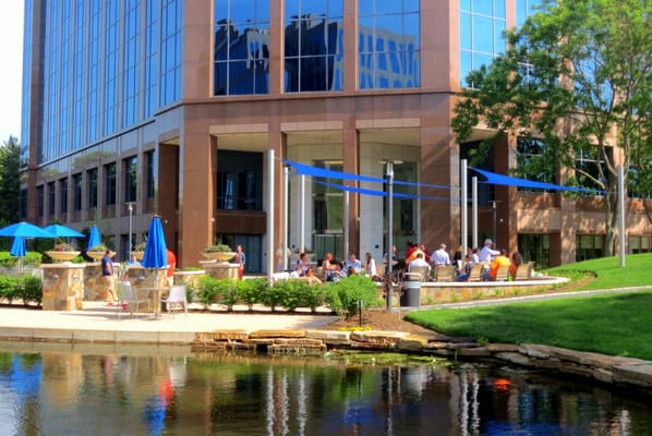 The outdoor experience in large office park in Fairfax County, VA.  New seat walls, tables, chairs, deep seat cushion couches, and arch bar.