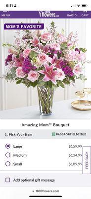 The large arrangement with a dozen pink roses, lilies and carnations along with white puffs.