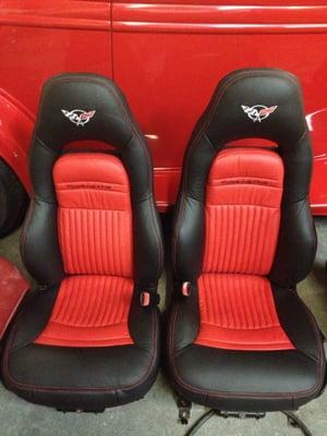 Black corvette seat redone n black/red two-tone with red stitching and embroidery.