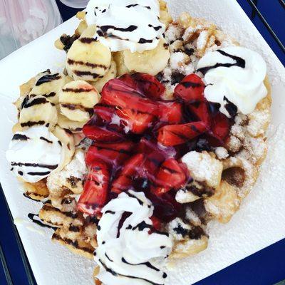 Our delicious Funnel Cake with strawberries, bananas, powder sugar, chocolate, lechera, and whip cream.