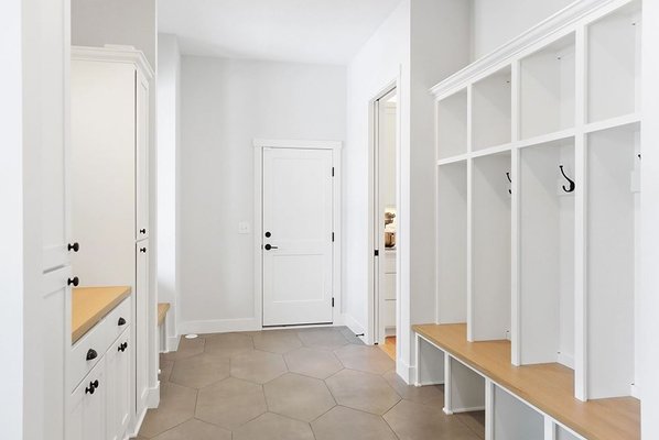 White Painted Mudroom custom cabinets for a clean sleek look. Located in Monticello Minnesota.